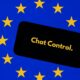 Black smartphone displaying the text "Chat Control" in yellow, set against a blue background with yellow stars evoking the European flag